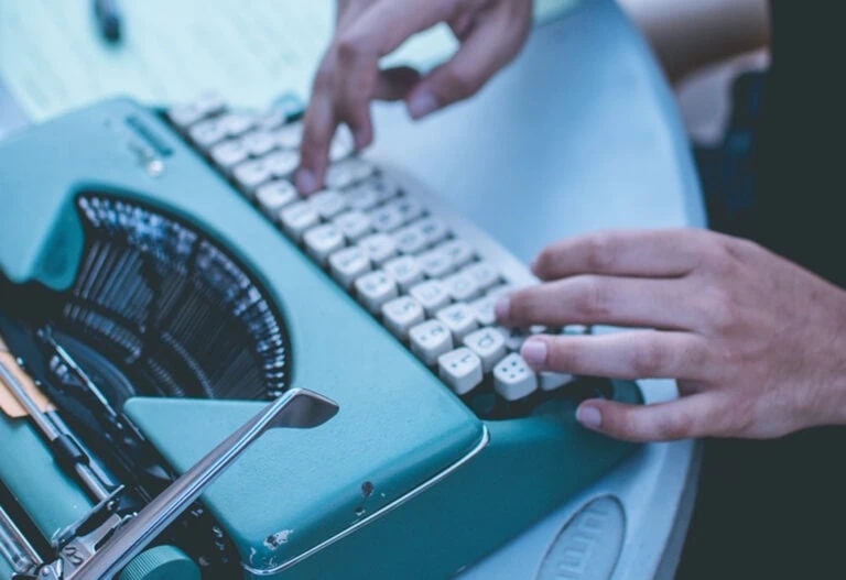 Man typing on old typewriter